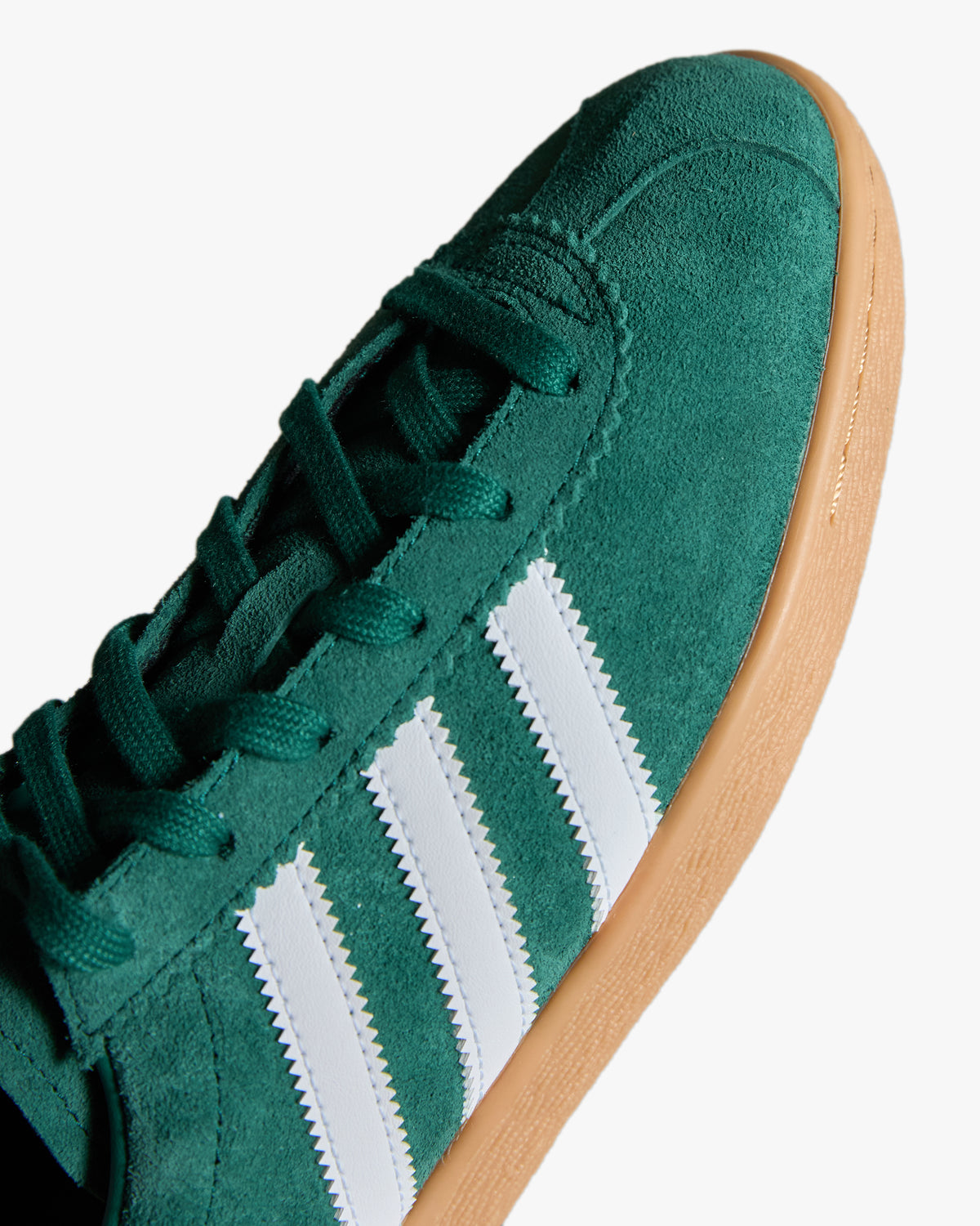 adidas stadt trainers green suede upper and white stripes at an angle
