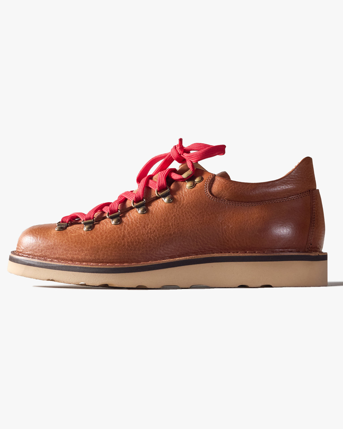 Brown leather Fracap shoe with red laces on a white background
