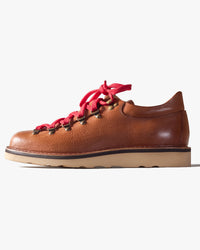 Brown leather Fracap shoe with red laces on a white background