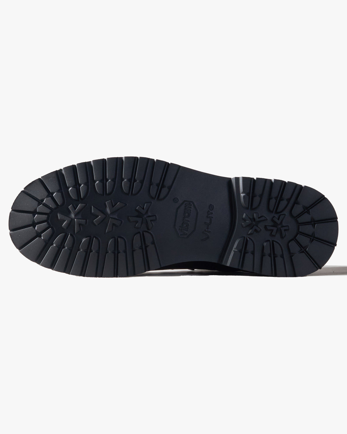Close-up of black boot sole on side a white background