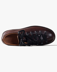 Dark Brown Fracap shoe with black braided straps on a white background
