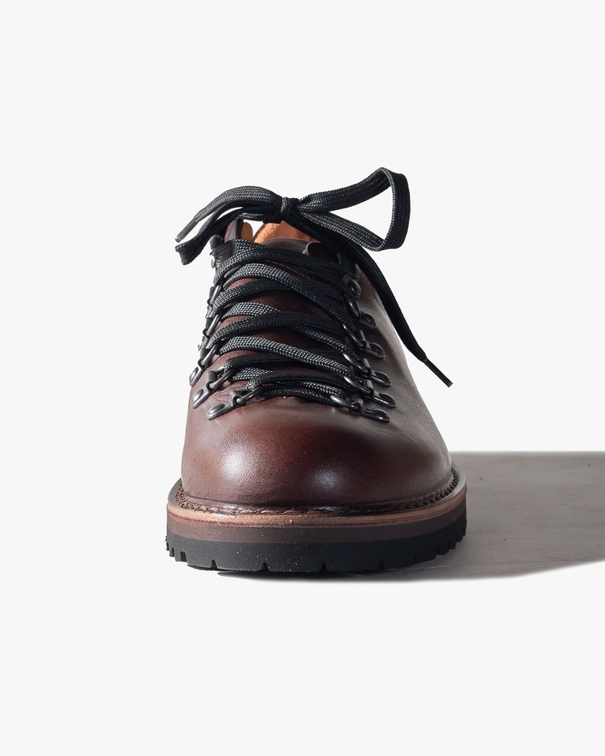 Brown leather Fracap shoe with black laces on a white background