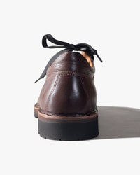Brown leather  Fracap shoe with black laces on a white background