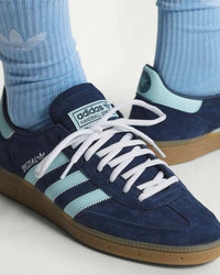 Adidas Handball Spezial Germany Trainers - Navy with White Stripes, modelled on feet, at angle