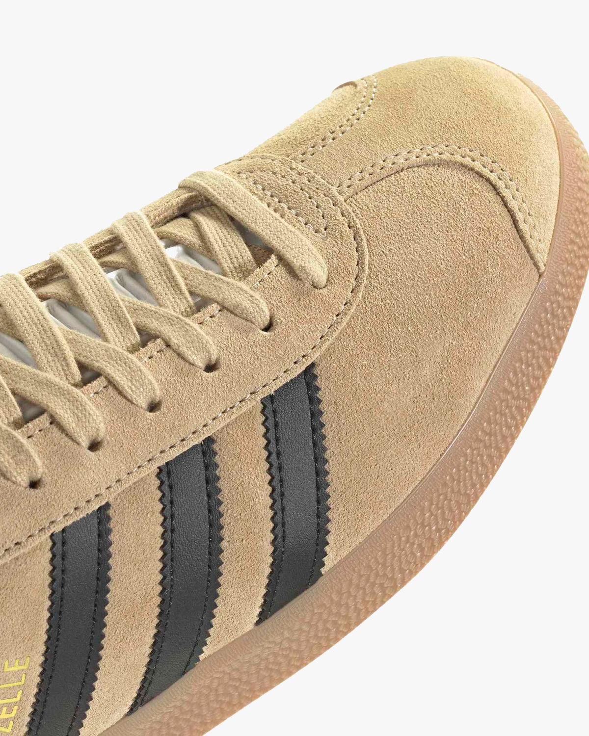 Adidas Gazelle Trainers - Magic Beige / Black / Gum at an angle toe view