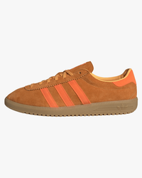 adidas brmd trainers orange with gold stripes from side against white background