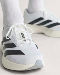 adidas adizero evo sl running shoes close up worn on model's feet