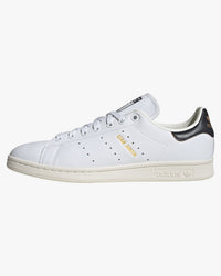 adidas stan smith trainers white with green heel tab side view against white background