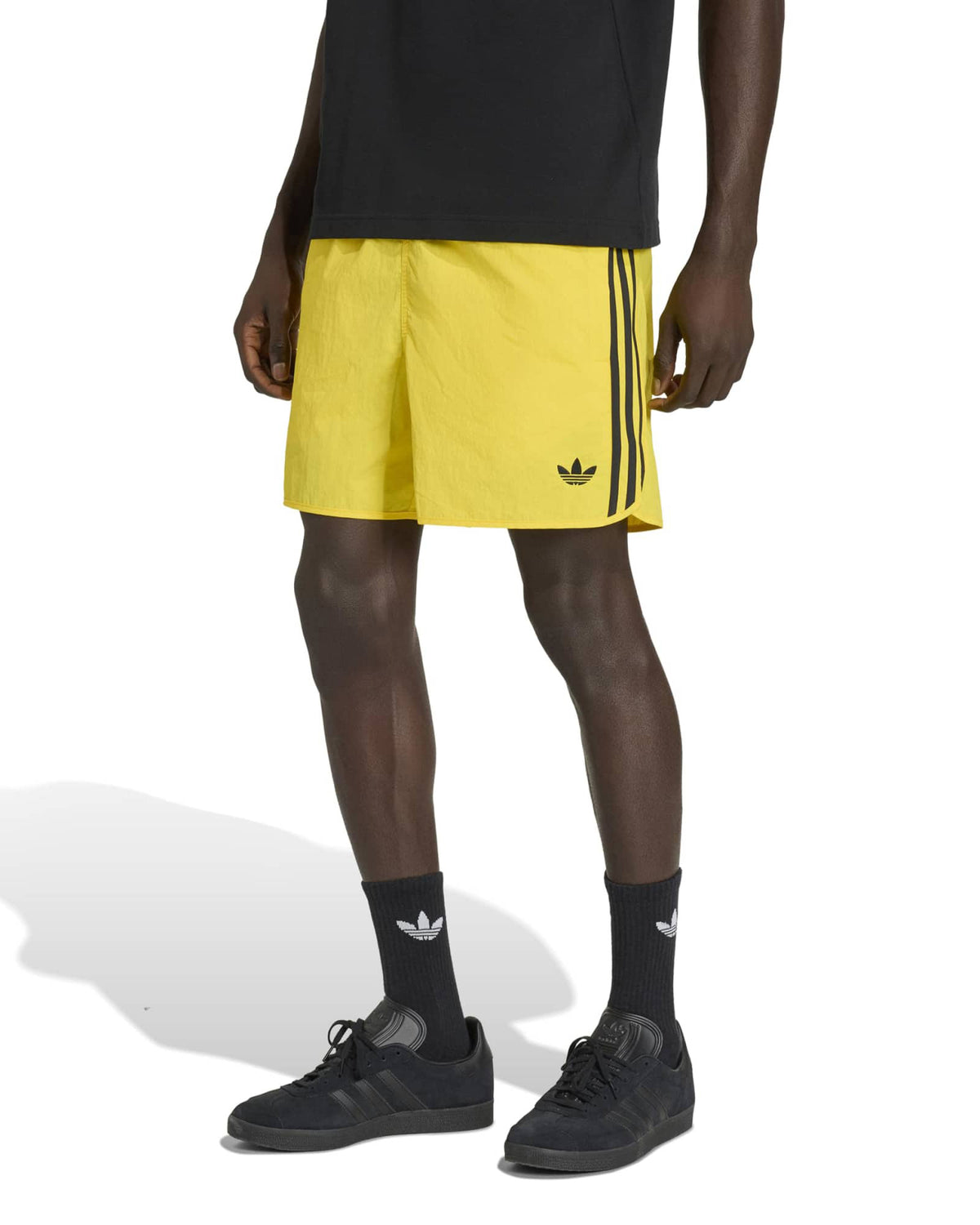 adidas sprinter shorts yellow styled with t shirt and trainers