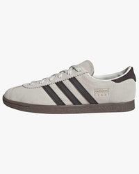 adidas stadt trainers white with brown stripes from side against white background