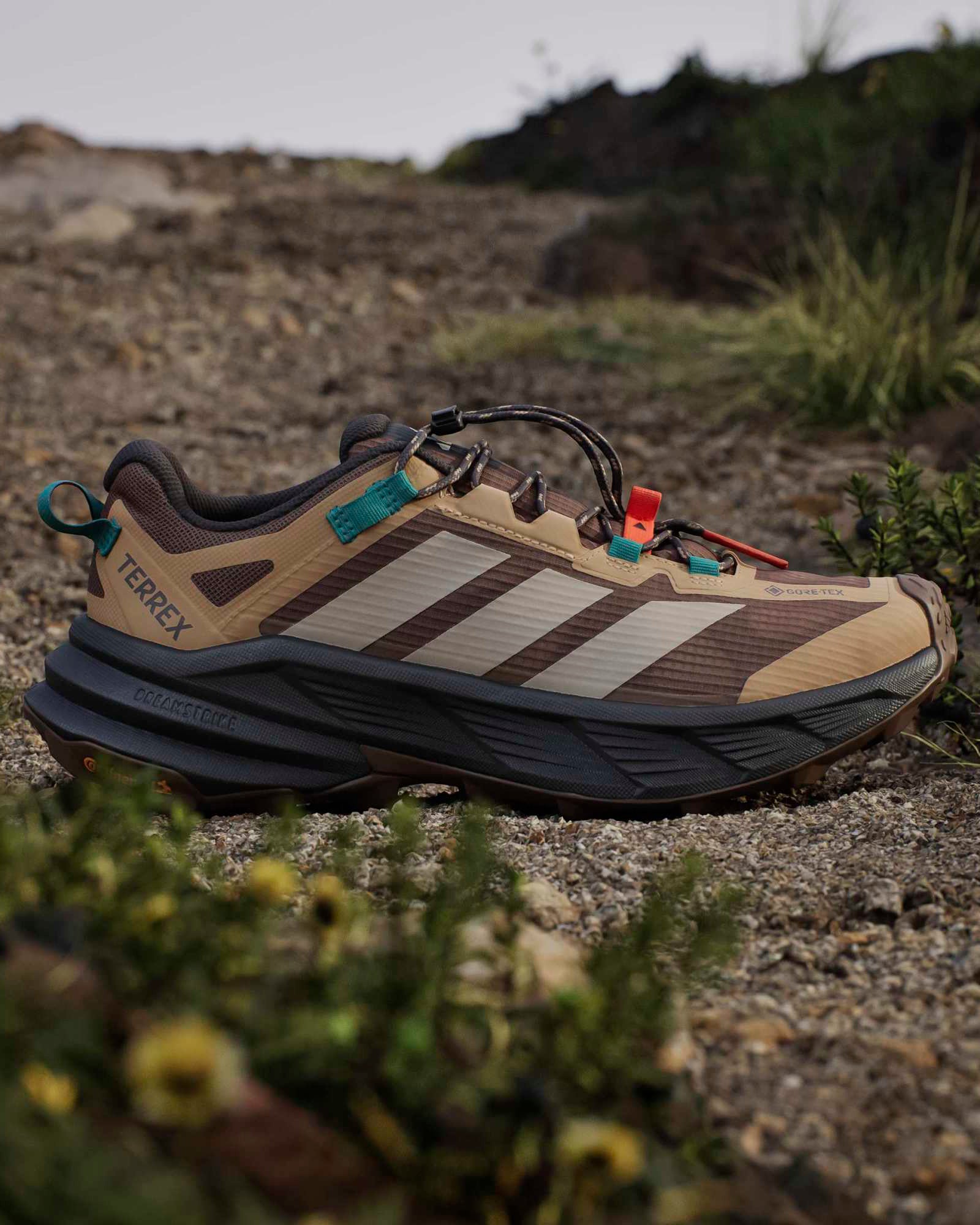 adidas terrex freehiker hiking shoes beige and teal on trail showing outsole gri