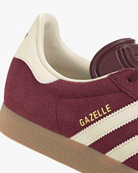 adidas gazelle maroon cream trainers at an angle showing heel and gum sole